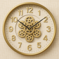 Decorative wall clock with gear design on a beige background
